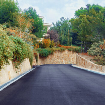 Picturesque concrete slope walkway with plants on the sides, background